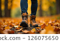 close-up of walking in hiking boots on autumn leaves, outdoor leisure and nature exploration 126075650