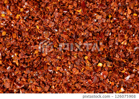 Spicy ground chili pepper close-up texture top view 126075908