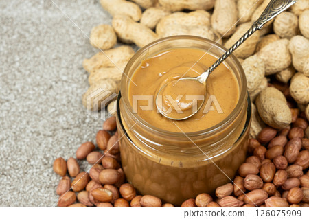 Peanut Butter in Spoon with Crunchy Peanut Background 126075909