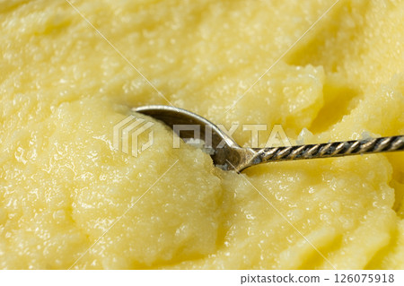 Natural Indian Traditional Ghee Butter Clarified Butter In Spoon Close-Up Natural Indian Traditional Ghee Butter Clarified Butter In Spoon Close-Up 126075918