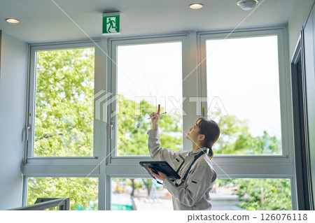 A woman checking the operation of evacuation guide lights 126076118