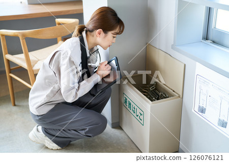 A woman inspecting an evacuation ladder A woman inspecting an evacuation ladder 126076121