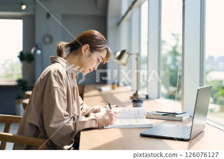 Woman studying in a coworking space Woman studying in a coworking space 126076127