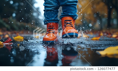 cheerful kid jumping in puddle on rainy first school day colorful boots 126077477