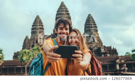 Traveling couple taking photos in front of historical landmarks 126077869