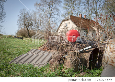 Pile of Scrap Metal and Old Materials in Front of Rural House Pile of Scrap Metal and Old Materials in Front of Rural House 126078366