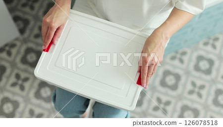 Woman open the first aid kit at home. First aid kit. 126078518
