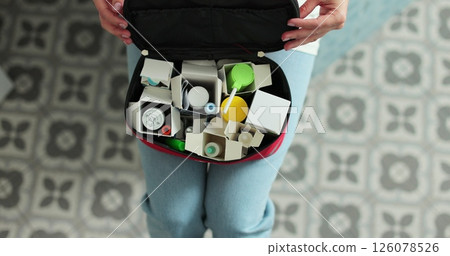 Woman open the first aid kit at home. First aid kit. 126078526