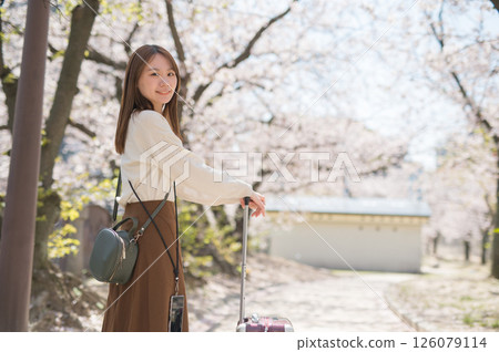 Woman traveling during cherry blossom season Woman traveling during cherry blossom season 126079114