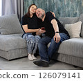 Husband and wife hugging on the couch 126079141