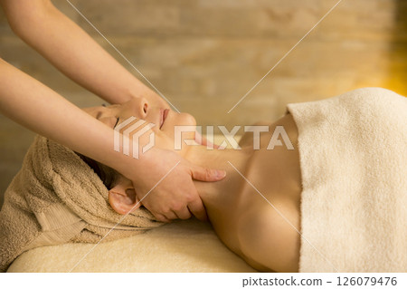 Senior woman receiving massage at beauty salon 126079476