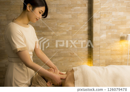 Senior woman receiving massage at beauty salon Senior woman receiving massage at beauty salon 126079478