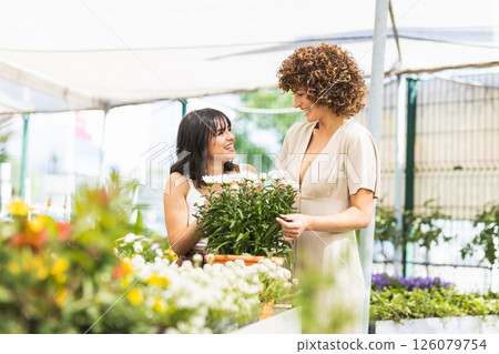 Two female garden center workers choosing white flowers 126079754