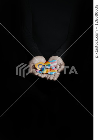 man holds some badges with different LGBTQ flags 126080038