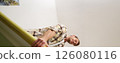 Vertical shot of man trying to press suitcase and close zipper, packing clothes for vacation. Tourist going on holiday, preparing for travelling abroad 126080116