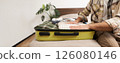 Cropped shot of male hands putting clothes inside suitcase, packing for business work trip or going on vacation, getting ready for holiday journey, preparing luggage 126080146