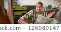 Image of shrugging man with road travel map, looks at camera with confused face, packs suitcase for holiday, plans a trip 126080147