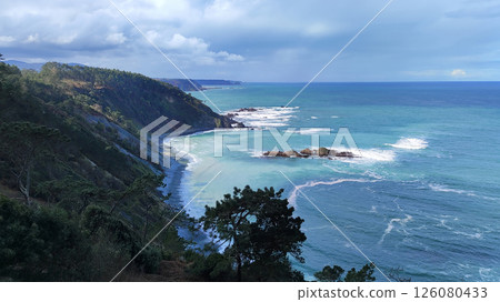 Breathtaking coastal landscape with dramatic cliffs, lush forest, and turquoise waters of the ocean. Asturias, Spain. 126080433