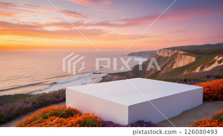 modern white platform surrounded by vibrant orange and purple flowers overlooks stunning coastal cliffside at sunset, with ocean waves gently meeting shore below. 126080493