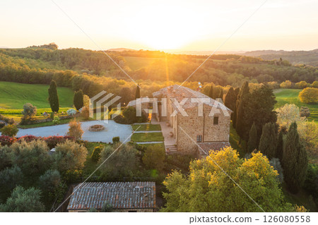 Tuscan farmhouse at sunset, showcasing Italian architecture and landscape 126080558