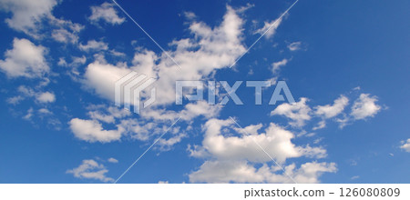 clear blue sky with a few clouds. The sky is very bright and the clouds are scattered throughout 126080809