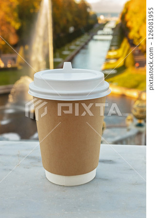 paper cup of natural coffee in front of fountains in St. Petersburg, Russia, on sunny autumn day paper cup of natural coffee in front of fountains in St. Petersburg, Russia, on sunny autumn day 126081955