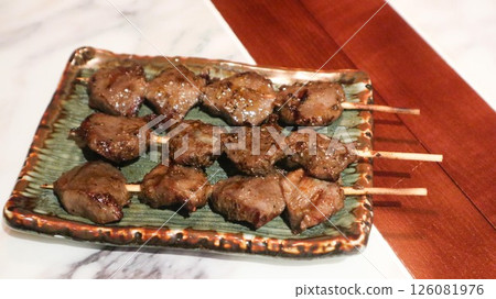 Close up of Japanese three skewers of grilled chicken gizzard on a plate in izakaya restaurant Close up of Japanese three skewers of grilled chicken gizzard on a plate in izakaya restaurant 126081976