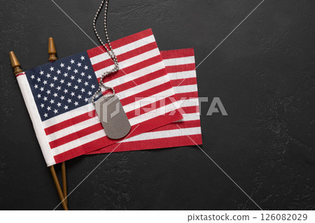 Military ID Dog Tag Hanging with American Flags on black background 126082029