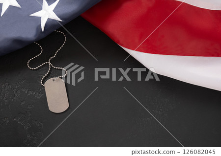 Military ID Dog Tag Hanging with American Flags on black background 126082045