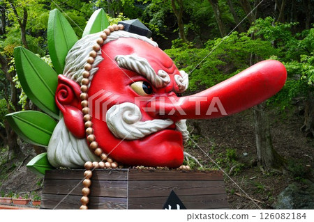 A giant Tengu face statue with fresh greenery in the background (Mount Kurama) A giant Tengu face statue with fresh greenery in the background (Mount Kurama) 126082184