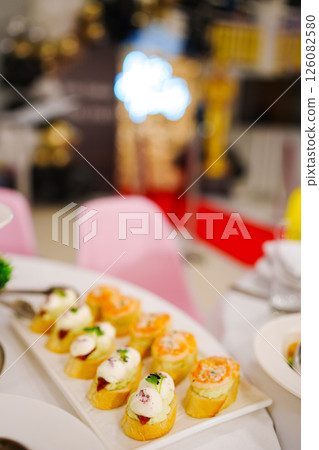 Assorted canapes for the festive table. Catering services for banquets.  126082580