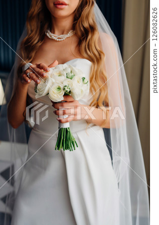 without a face. Bride in white off-the-shoulder dress with bouquet. without a face. Bride in white off-the-shoulder dress with bouquet. 126082626