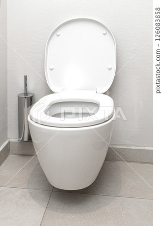 White ceramic toilet bowl with open lid in modern bathroom 126083858