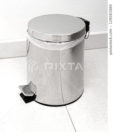 Small metal trash can with pedal in the bathroom 126083860