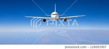 White passenger airplane flying high above clouds on blue sky background White passenger airplane flying high above clouds on blue sky background 126083907
