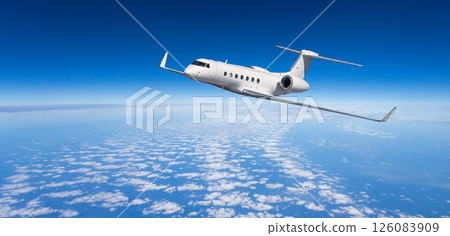 White private jet flying above clouds in blue sky White private jet flying above clouds in blue sky 126083909