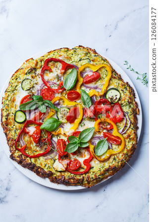 Vegan pizza on zucchini crust with vegetables and mozzarella. 126084177