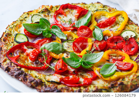 Vegan pizza on zucchini crust with vegetables and mozzarella. 126084179