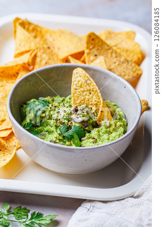 Avocado guacamole spread with nacho corn chips. Avocado guacamole spread with nacho corn chips. 126084185