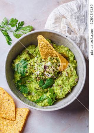 Avocado guacamole spread with nacho corn chips. Avocado guacamole spread with nacho corn chips. 126084186