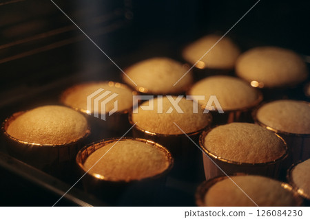 Muffins Baking in the Oven with Golden Tops Muffins Baking in the Oven with Golden Tops 126084230