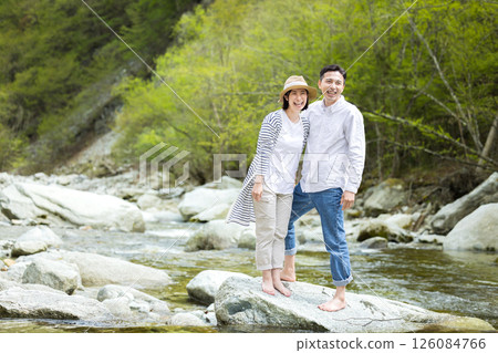 Men and women who enjoy playing in the water on the riverbed Men and women who enjoy playing in the water on the riverbed 126084766
