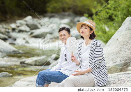 Men and women who enjoy playing in the water on the riverbed Men and women who enjoy playing in the water on the riverbed 126084773