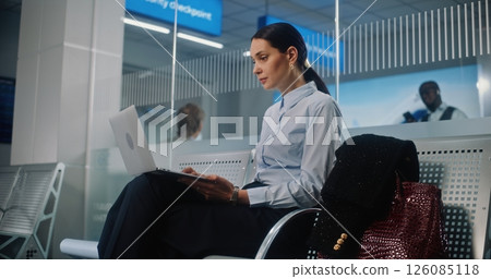 Successful Businesswoman Using Laptop Computer, Waiting for Flight in Departure Lounge 126085118