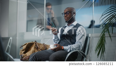 Airport Terminal: Successful Entrepreneur Using Smartphone and Drinking Coffee 126085211