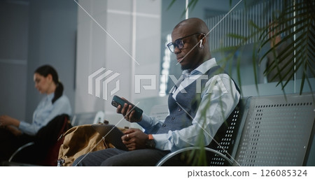 Businessman Using Digital Tablet and Smartphone, Waiting for Flight in Departure Lounge 126085324