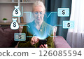 Senior woman interacting with augmented reality financial icons on smartphone at home 126085594