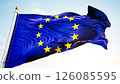 European union flag waving against clear blue sky in gentle breeze 126085595