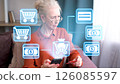 Senior woman engaging in digital shopping experience with holographic interface 126085597