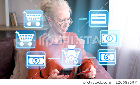 Senior woman engaging in digital shopping experience with holographic interface 126085597